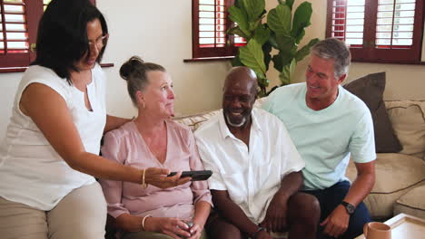 diverse group of diverse seniors laughing and enjoying conversation at home