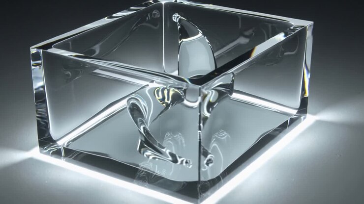 Moving camera revealing clear cube showing ribbon shifting across faces on lit base for display