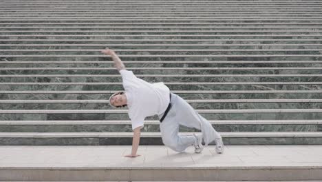 breakdancer performing various moves on urban steps