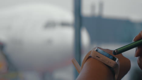 woman using smart watch to type phone number