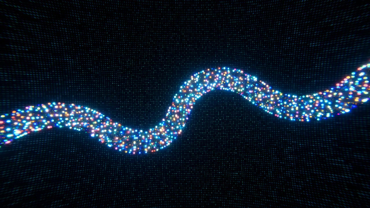 Puntos densos de luz azul, roja y blanca forman una banda ondulada continua a través de un campo negro, con la hebra curva moviéndose sutilmente mientras mantiene su forma horizontal fluida