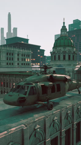 a military helicopter sits on a rooftop in a city