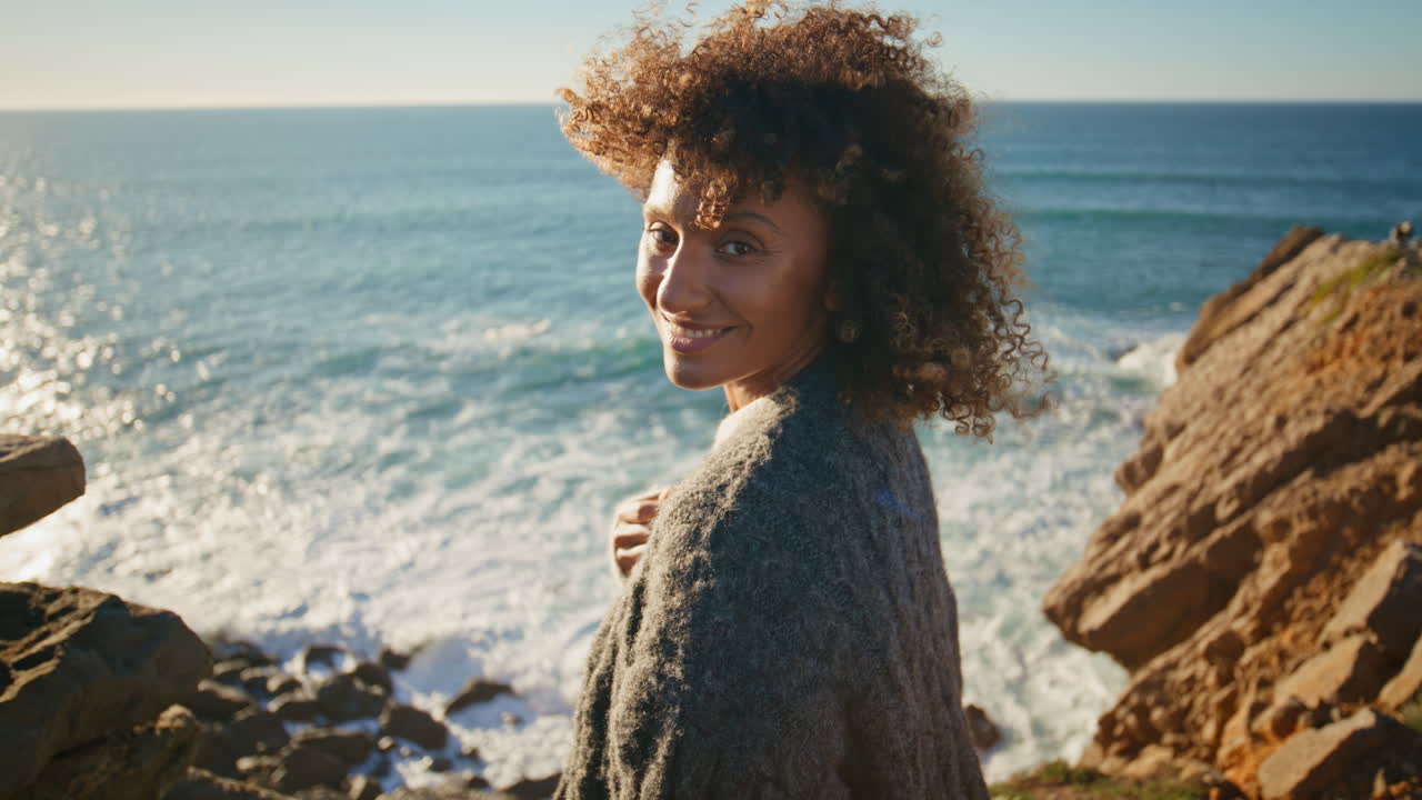 Girl walking cliff edge sunny day closeup. Happy tourist enjoying vacation alone