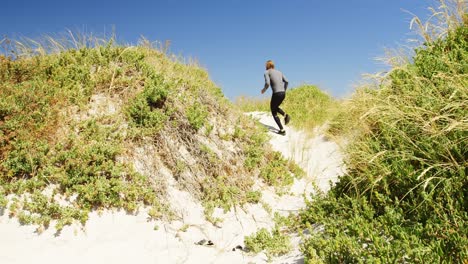 triathlete man jogging on a trail