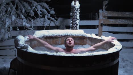 man taking a freezing cold, ice bath in a outdoor pool