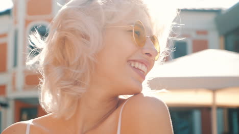 smiling woman in sunglasses outdoors