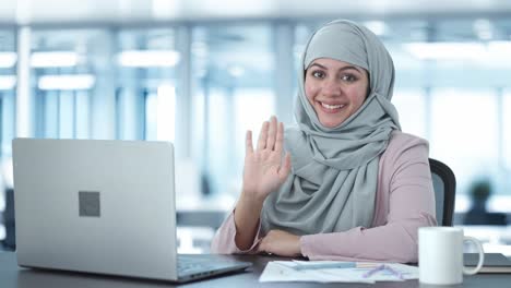 happy muslim businesswoman saying hi