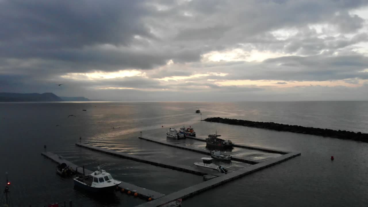 Aerial Looking Out To English Channel From The Cobb Marina At Lyme Regis. Pedestal Up