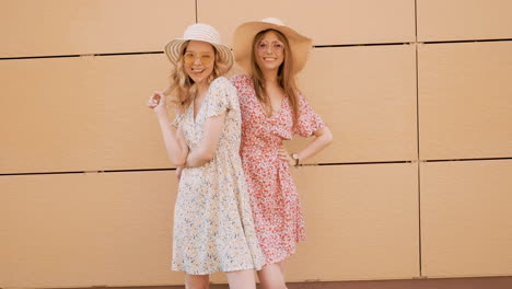 two women in floral dresses and hats