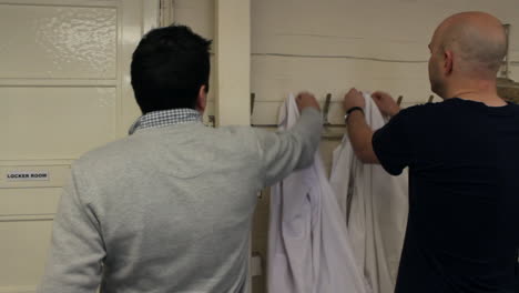 scientists hanging up lab coats after finishing work in a laboratory