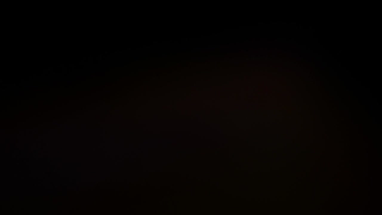 Abstract red flash spots or lens flare on black background