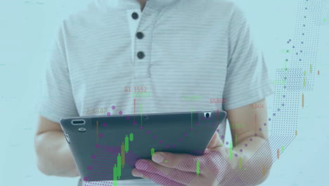 using tablet with financial data and graphs, man analyzing in office
