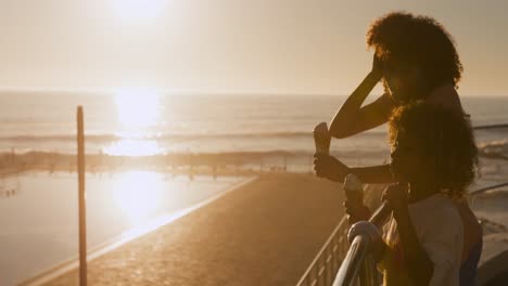 mother and son eating ice cream at the sunset