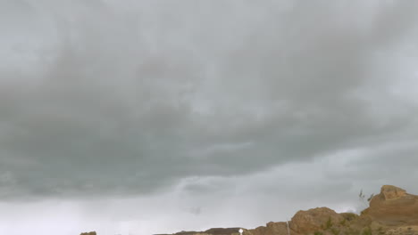 a lightning bolt hits just in front of the camera while driving through the desert