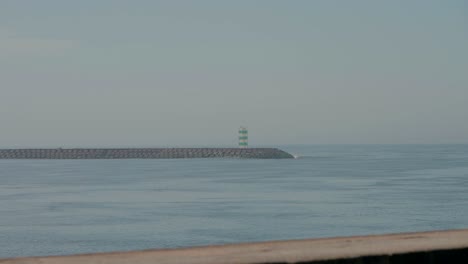 gloomy seascape with distant lighthouse