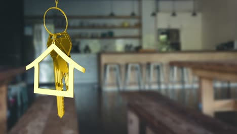 Animation-of-hanging-golden-house-keys-against-interior-of-a-bar