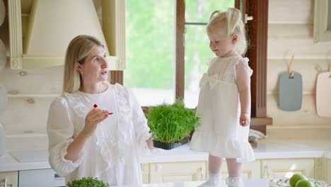 mother and daughter in kitchen with microgreens
