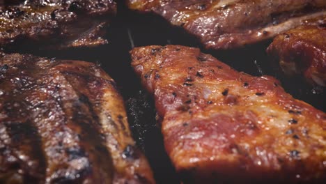 Tasty-ribs-cooking-on-barbecue-grill-for-summer-outdoor-party