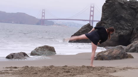 Woman-Dances-Alone-on-the-Beach,-Foggy-Day,-Passion-and-Expression