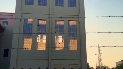 Disused-Warehouse-look-at-Old-East-Perth-Power-Station-in-golden-twilight-through-barbed-wire