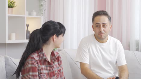 a man puts a ring on his wife's finger.