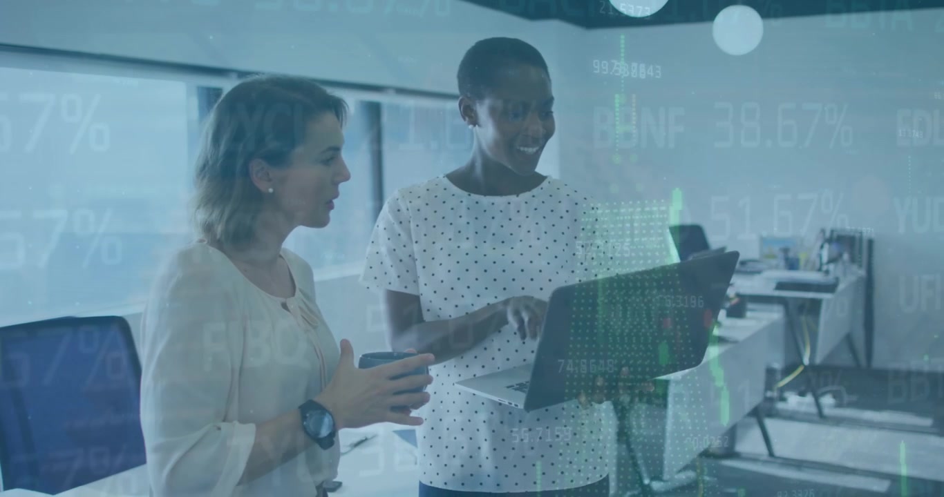 Animation of financial data processing over two diverse female colleagues discussing at office