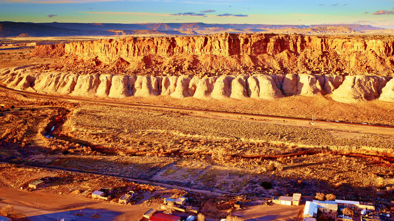 Drone shot of red mesa outcrop in a dramatic New Mexican landscape