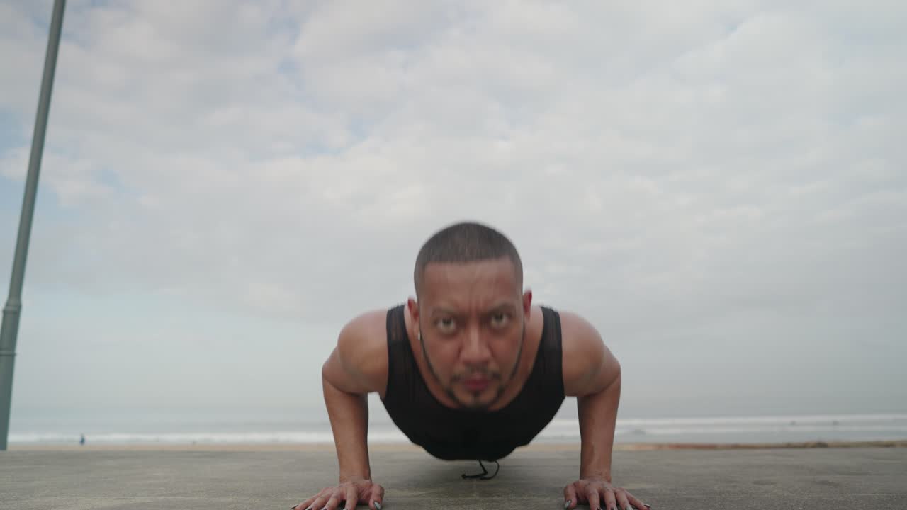 Man Doing Push-Ups on the Beach