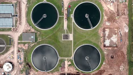 aerial overhead top down view of water treatment plant. birds flying around.