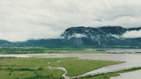 Fly-over-estuary-towards-massive-rock-face