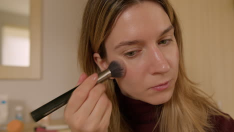 girl doing makeup on herself at home