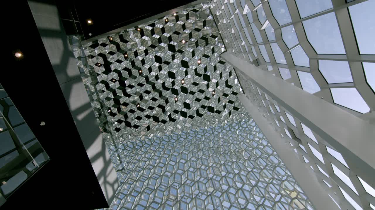 Modern architecture of the Reykjavik Opera House with intricate geometric ceiling patterns