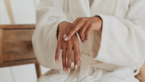 woman applying moisturizer to her hands