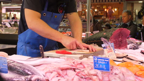 fishmonger preparing some fish on a local market sete france herault occitanie