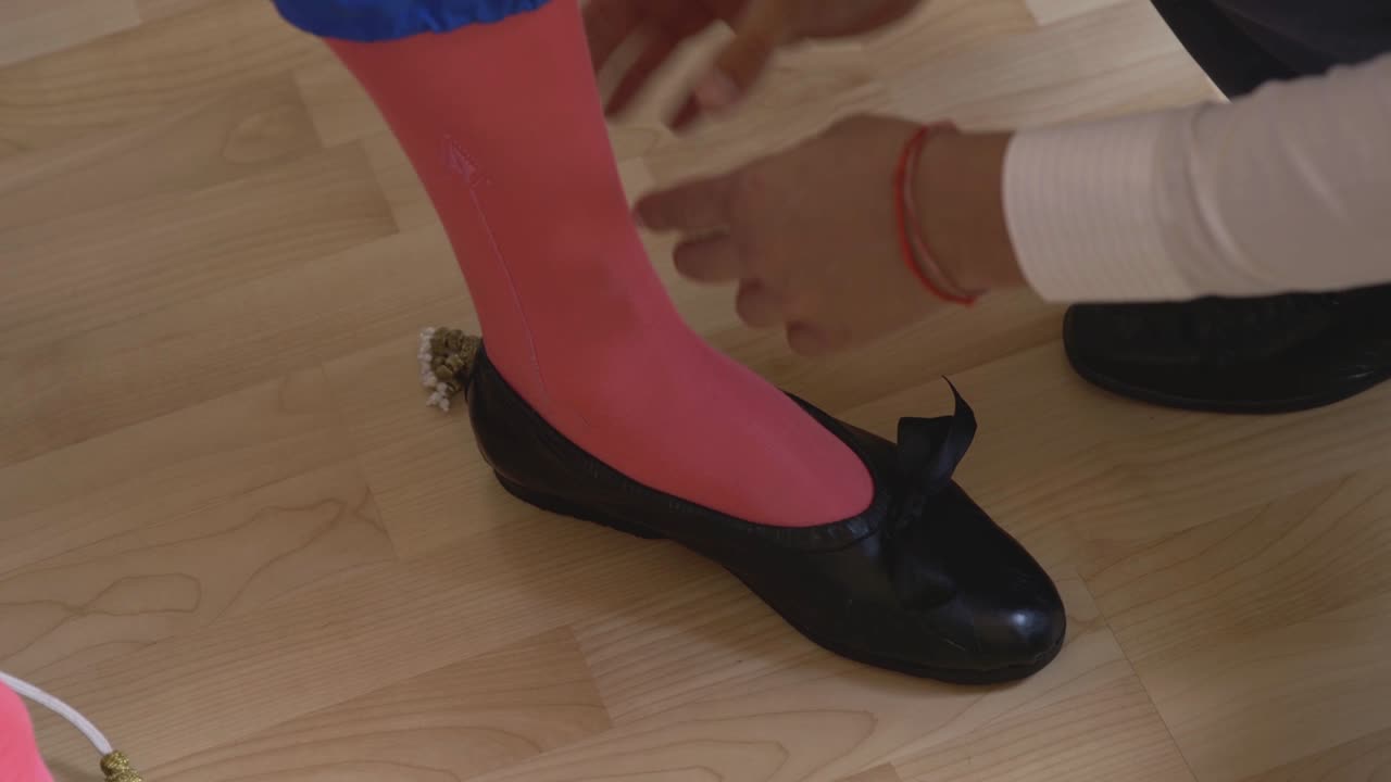 A person getting dressed in traditional Spanish costume