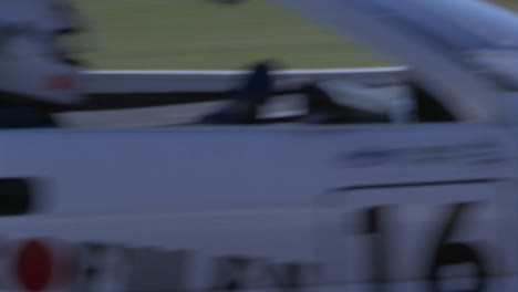 racing cars compete on a circuit track 1
