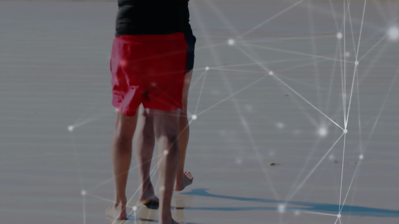 Animation of network of connections over senior caucasian couple walking on beach with surfboard