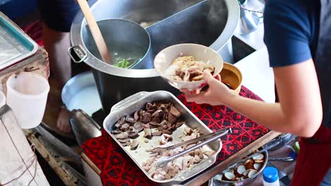preparing and serving noodles at a market