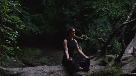 Relaxed-young-girl-in-easy-yoga-pose,-forest-meadow