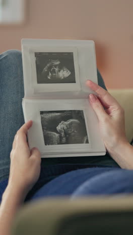 a pregnant woman looks at an ultrasound image of her baby