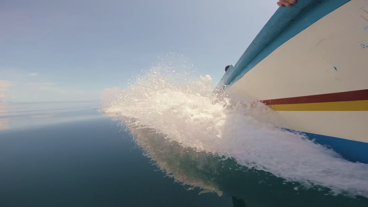 Boat Cutting Through Water on a Clear Day