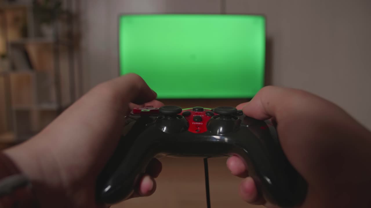 Hands Gamer Using Joystick Play A Game With Green Screen Tv At Home