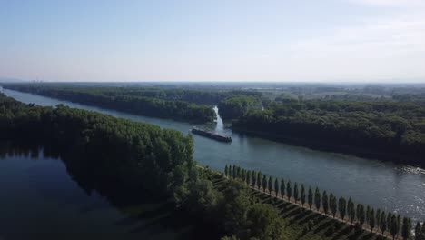 time lapse of a fixed position drone filming a cargo ship travelling down stream on the rhine river in europe