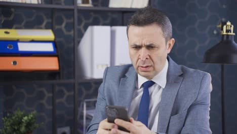 mature businessman sitting at office desk frustrated with frustration and anger concept.