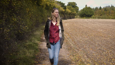 woman walking in an autumn field