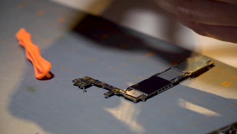 electronic component on table with moving shadow of hands