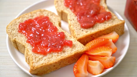 homemade whole wheat bread with strawberry jam and fresh strawberry