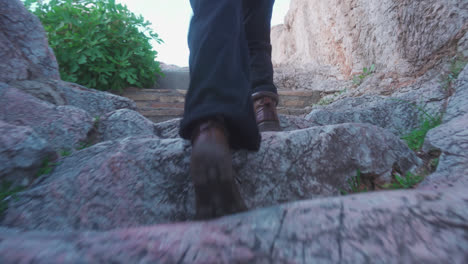 walking up stone stairway in boots