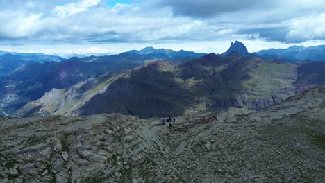 a group of explorers set off on an excursion to the ip valley, near canfranc in the autonomous community of aragon in spain. the pic de midi d'ossau is clearly visible in the background