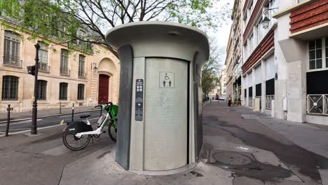 a man makes a call from a street phone booth.